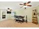 This cozy dining room features hardwood floors, a ceiling fan, and a view to the backyard at 6430 Yellowstone St, Orlando, FL 32807