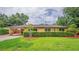 Charming single-story home featuring a manicured lawn and welcoming covered entryway at 6430 Yellowstone St, Orlando, FL 32807