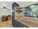 Kitchen with gray cabinets, stone countertops, open shelving, and natural light from the window at 6430 Yellowstone St, Orlando, FL 32807