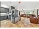 Open floor plan: Kitchen flows into the living room, featuring tile floors and stainless steel refrigerator at 6430 Yellowstone St, Orlando, FL 32807