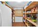 Spacious walk-in pantry with ample shelving and storage, and features hardwood flooring at 6430 Yellowstone St, Orlando, FL 32807