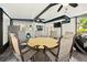 Enclosed patio with outdoor dining area, ceiling fans, mounted television, and stainless steel refrigerator at 6430 Yellowstone St, Orlando, FL 32807
