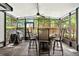Enclosed patio with outdoor dining, grill, and views of landscaped backyard at 6430 Yellowstone St, Orlando, FL 32807