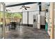 Enclosed patio with outdoor dining, stainless steel fridge, and views of the backyard at 6430 Yellowstone St, Orlando, FL 32807
