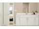 Bright bathroom vanity with white cabinets, light countertops, and modern fixtures at 669 Terrapin Dr, Debary, FL 32713