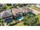 Aerial view of home with a sparkling backyard pool and a fenced in backyard at 7398 Gathering Ct, Reunion, FL 34747