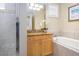 Full bathroom features a shower, soaking tub, granite-topped vanity, and a decorative light fixture at 7398 Gathering Ct, Reunion, FL 34747