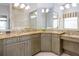 Bathroom featuring double sinks, granite countertops, and custom wood cabinetry at 7398 Gathering Ct, Reunion, FL 34747