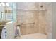 Luxurious walk-in shower features neutral tiling, built-in shelving and grab bar for safety and convenience at 7398 Gathering Ct, Reunion, FL 34747