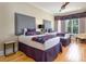 Charming bedroom features hardwood floors, two beds, modern decor, and lots of natural light at 7398 Gathering Ct, Reunion, FL 34747