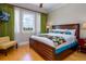 Bedroom features a large bed, vibrant curtains, a wooden frame and a large window with a view at 7398 Gathering Ct, Reunion, FL 34747