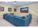 Entertainment room features an oversized sectional sofa, custom lighting and large screen TV at 7398 Gathering Ct, Reunion, FL 34747