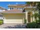 Charming home with a tile roof, brick driveway, two car garage, and landscaped garden at 7398 Gathering Ct, Reunion, FL 34747