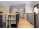 Upstairs hallway features wood floors and railing that overlooks the entryway at 7398 Gathering Ct, Reunion, FL 34747