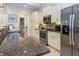 Bright kitchen with stainless steel appliances, granite countertops, and ample cabinet space at 7398 Gathering Ct, Reunion, FL 34747