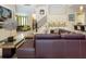 Bright living area with multiple seating areas, a staircase, and a view into another room at 7398 Gathering Ct, Reunion, FL 34747