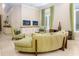 Bright and airy living room featuring a comfortable curved sofa and many windows at 7398 Gathering Ct, Reunion, FL 34747