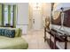 Inviting living room featuring a stylish mirror, comfortable seating, and tiled floors at 7398 Gathering Ct, Reunion, FL 34747