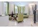 Cozy living room with a comfortable curved sofa and many windows at 7398 Gathering Ct, Reunion, FL 34747