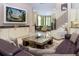 Open-plan living room with built-in cabinets, a television, and a view into another living area at 7398 Gathering Ct, Reunion, FL 34747