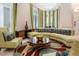 Inviting living room with large windows, a comfortable curved sofa, and stylish decor at 7398 Gathering Ct, Reunion, FL 34747