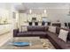 Cozy living room with a plush leather sofa and open bar-style kitchen with barstool seating at 7398 Gathering Ct, Reunion, FL 34747