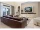 Bright and airy living area with a television, built-in cabinets, and a patio view with waterfront access at 7398 Gathering Ct, Reunion, FL 34747