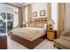 Elegant bedroom with a king bed, bedside tables, and sliding glass doors at 7398 Gathering Ct, Reunion, FL 34747