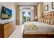 Bedroom featuring a large bed, dresser, and sliding glass doors to the pool at 7398 Gathering Ct, Reunion, FL 34747
