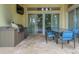 Outdoor patio seating area with built in grill and views of the pool at 7398 Gathering Ct, Reunion, FL 34747