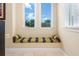Charming window seat offers a cozy nook with natural light and views of mature trees at 7398 Gathering Ct, Reunion, FL 34747