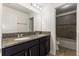 Bathroom with double vanity, granite countertop and tiled shower at 7816 Winter Wren St, Winter Garden, FL 34787