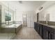 Well-appointed bathroom with soaking tub, glass shower, and dual sink vanity at 7816 Winter Wren St, Winter Garden, FL 34787