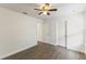 Bedroom with hardwood floors, ceiling fan, and two doorways at 7816 Winter Wren St, Winter Garden, FL 34787