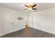 Bedroom with wood-style floors, white walls, ceiling fan and tv mount at 7816 Winter Wren St, Winter Garden, FL 34787