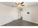 Bedroom featuring hardwood floors, ceiling fan, and a mounted TV at 7816 Winter Wren St, Winter Garden, FL 34787