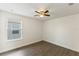 Bedroom featuring hardwood floors, ceiling fan, and large window with blinds at 7816 Winter Wren St, Winter Garden, FL 34787