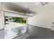 Spacious two car garage with epoxy floor and an automatic garage door at 7816 Winter Wren St, Winter Garden, FL 34787