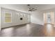 Bright living area featuring new flooring, a modern ceiling fan, and multiple windows at 7816 Winter Wren St, Winter Garden, FL 34787