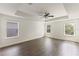 Bright and airy main bedroom featuring hardwood floors and three large windows at 7816 Winter Wren St, Winter Garden, FL 34787