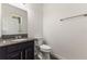 Well-maintained powder room featuring a granite vanity and neutral fixtures for a clean, modern look at 7816 Winter Wren St, Winter Garden, FL 34787