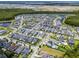 A bird's-eye view of a community revealing houses, roads, landscaping, and nearby amenities at 8427 Modiano St, Orlando, FL 32827