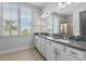 Bright bathroom features dual sinks, a large mirror, and plenty of counter space for convenience at 8427 Modiano St, Orlando, FL 32827