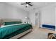 Cozy bedroom with a comfortable bed, soft carpet, a ceiling fan, and access to the bathroom at 8427 Modiano St, Orlando, FL 32827