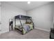 Bedroom features a bunk bed, carpet, and a mirror next to the room's entrance door at 8427 Modiano St, Orlando, FL 32827