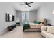 This spacious bedroom features a ceiling fan, a comfy bed, and a large window for natural light at 8427 Modiano St, Orlando, FL 32827