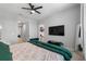 This well-lit bedroom provides a cozy bed, tv, and doorway that offers flexible accessibility at 8427 Modiano St, Orlando, FL 32827