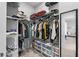 This walk-in closet is equipped with plenty of shelving and racks to keep belongings organized at 8427 Modiano St, Orlando, FL 32827