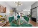 Open-concept dining area with a large glass table, stylish chairs, and open access to living areas at 8427 Modiano St, Orlando, FL 32827