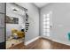 Stylish entryway with modern decor, including a 'hello' wall decal, and wood-look flooring at 8427 Modiano St, Orlando, FL 32827